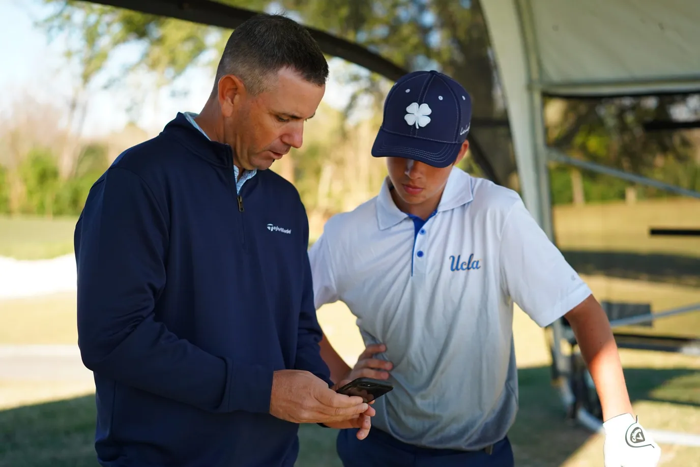 CAMPUS Academy coach Scott Hause reviewing swing data with a junior golfer